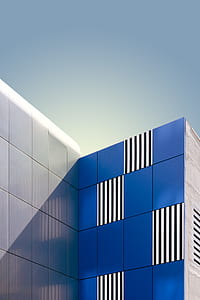 blue and gray concrete buildings with lines at daytime thumbnail