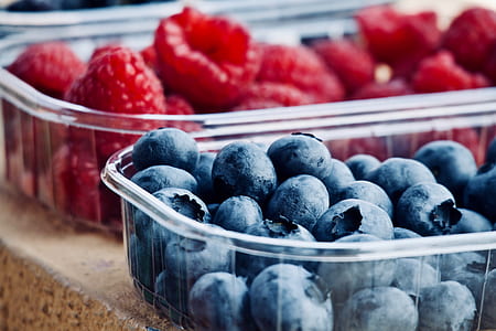 blueberries and raspberries in clear plastic containers thumbnail