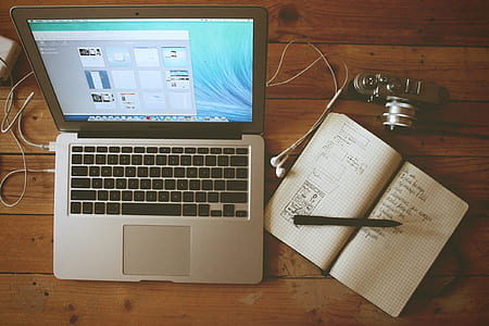 turned on MacBook Air next to opened notebook thumbnail