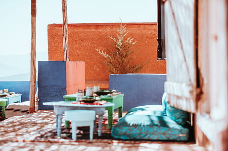green and white table near teal seat thumbnail