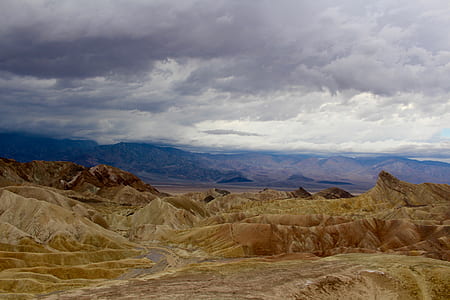 aerial photography brown mountains under gray sky atdaytime thumbnail