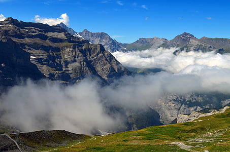 gray rocky mountain surrounded by clouds thumbnail