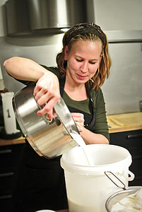 woman pouring white liquid into white bucket thumbnail