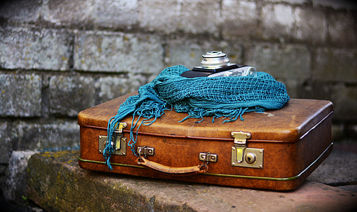 selective focus photography of brown suitcase on table thumbnail