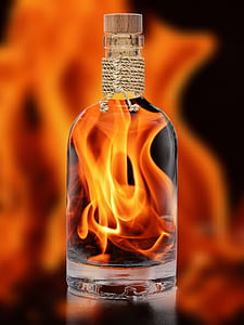 clear glass bottle with fire in side photo thumbnail