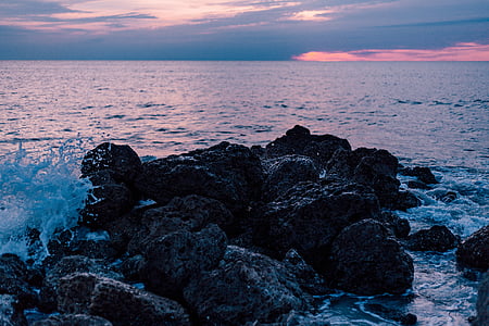 black rocks on seashore thumbnail