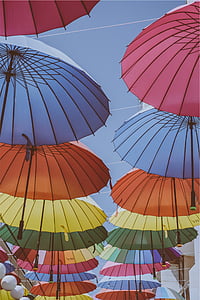 low angle photography of assorted-color hanged umbrellas taken during daytime thumbnail