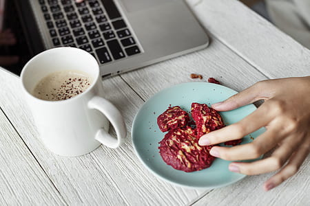 person picking cookie on teal ceramic saucer thumbnail