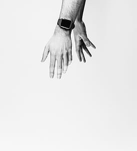 grey scale photo of two hands thumbnail