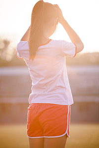 woman wearing white shirt and orange shorts during daytime thumbnail