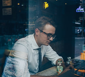man sitting in front of table thumbnail
