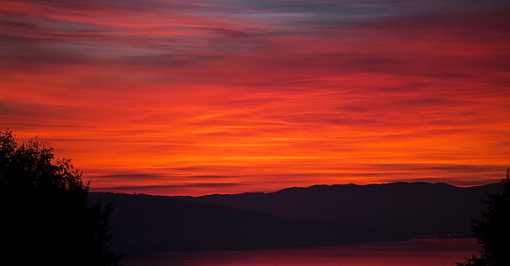 silhouette of mountain against red sunlight thumbnail