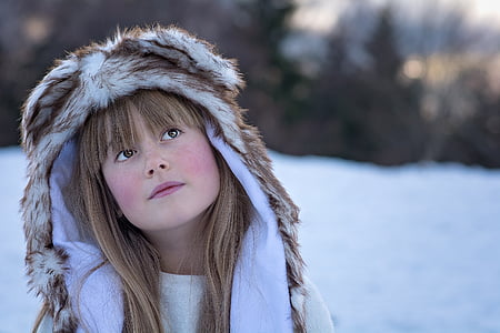 girl wearing brown and white fur hooded top thumbnail