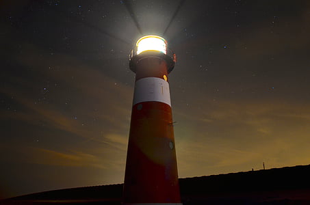 lighthouse during nighttime low angle photography thumbnail