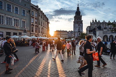people walking near building during sunset thumbnail