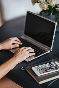 Woman using a laptop by a round breakfast table thumbnail