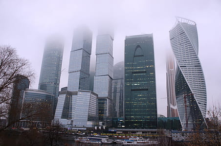 high-rise buildings in urban area covered in white fog thumbnail