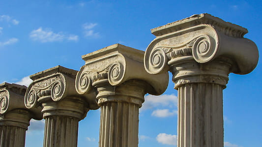 four columns during cloudy day thumbnail