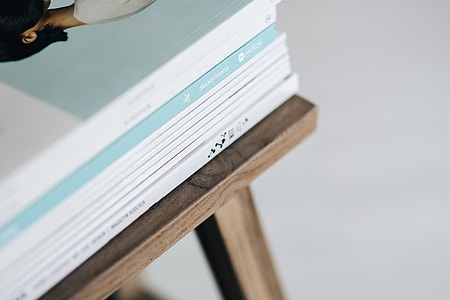 Stack of magazines on the wooden stool thumbnail