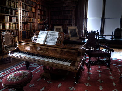 grand piano near book shelf and chair thumbnail