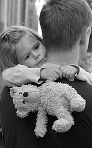 grayscale photo of girl hugging man thumbnail