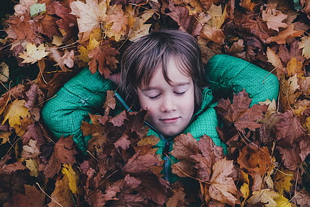 girl taking photo under leaves thumbnail