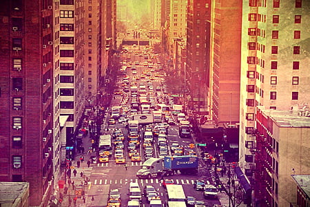 buildings in between road with vehicles thumbnail