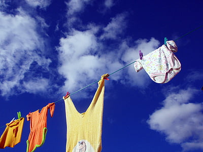 four assorted-color clothes hanging on rope thumbnail