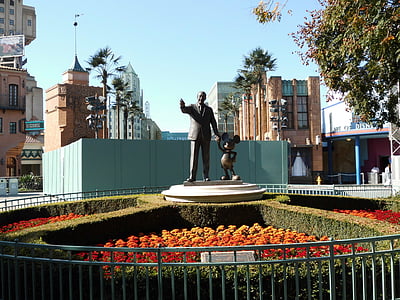 man and Mickey Mouse statue thumbnail