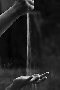 grayscale photo of person dropping powder thumbnail