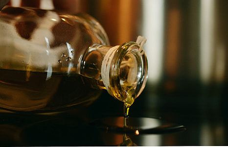 clear glass cognac bottle spilling its contents thumbnail