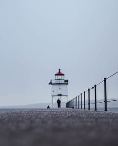 person walking near lighthouse thumbnail