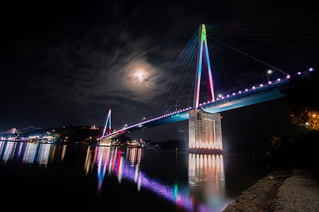 lighted bridge during night time thumbnail