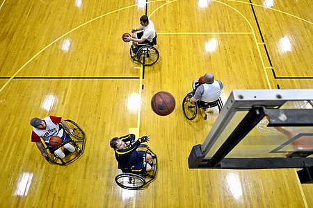 four person riding on wheelchairs playing basketball thumbnail