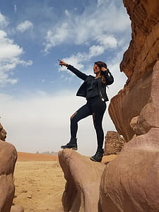 Photo of Woman Standing on Rock Formation thumbnail