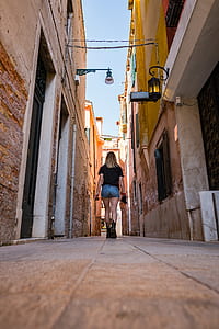 woman walking near city buildings thumbnail