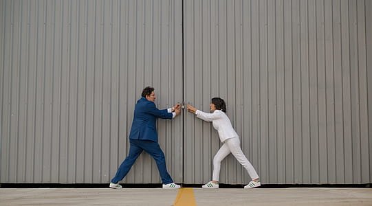 man and woman opening the warehouse door thumbnail