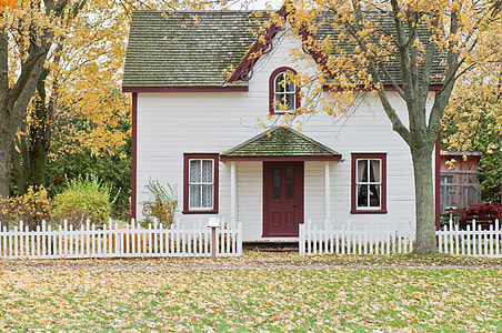 white, maroon, and gray wooden house surrounded by trees during daytime thumbnail