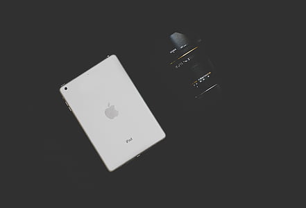 white iPad beside black camera lens thumbnail