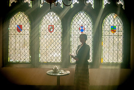 woman wearing black coat standing beside round coffee table thumbnail