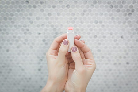 person holding lipbalm thumbnail