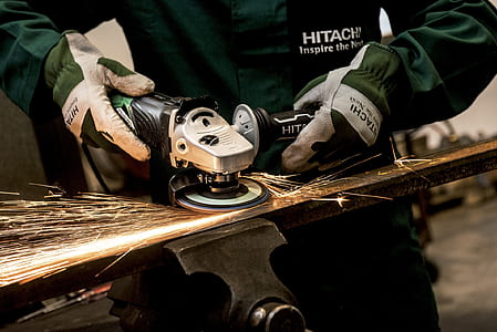 Person Holding Black and Gray Hitachi Angle Grinder thumbnail