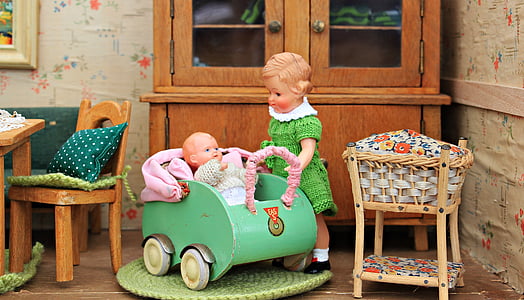 girl standing beside baby on stroller figurines thumbnail