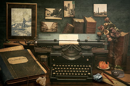 black Royal typewriter beside black book on table thumbnail