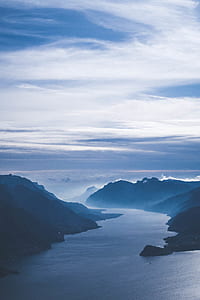 body of water near mountains thumbnail