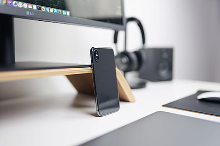 space gray iPhone X leaning on gray desk thumbnail