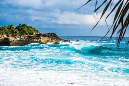 Waves on the ocean crashing on shore in Indonesia thumbnail