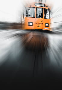 panning photography of orange train thumbnail