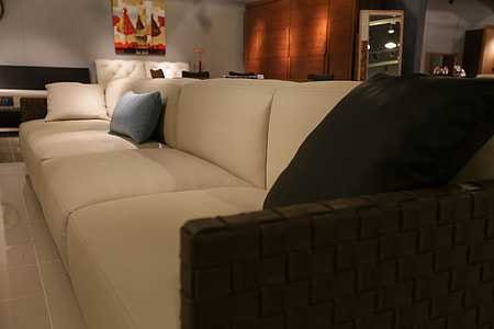 white leather 4-seat sofa with pillows in living room thumbnail