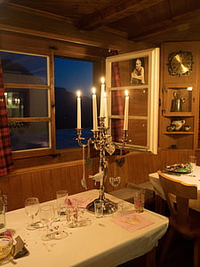 lit candles on stainless steel candelabra thumbnail